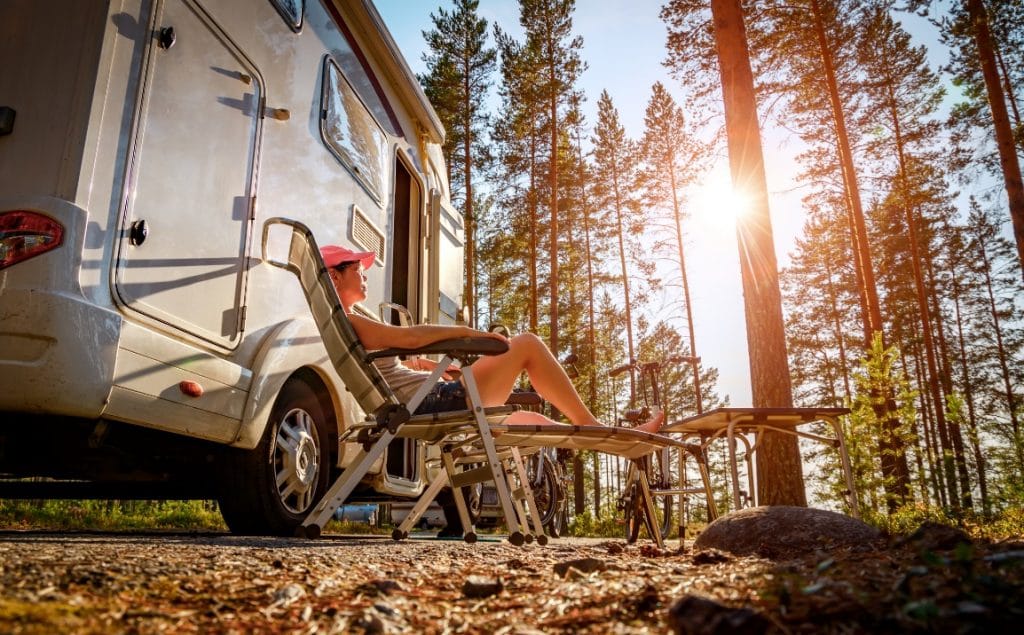 lady outside well packed motorhome