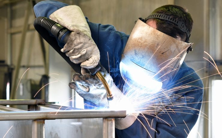 welder works in metal construction - construction and processing of steel components