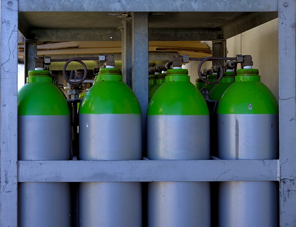 green and silver gas bottles lined up