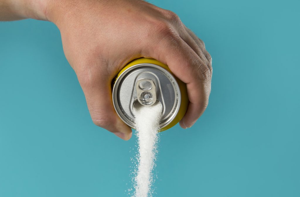 open soda can with sugar pouring out