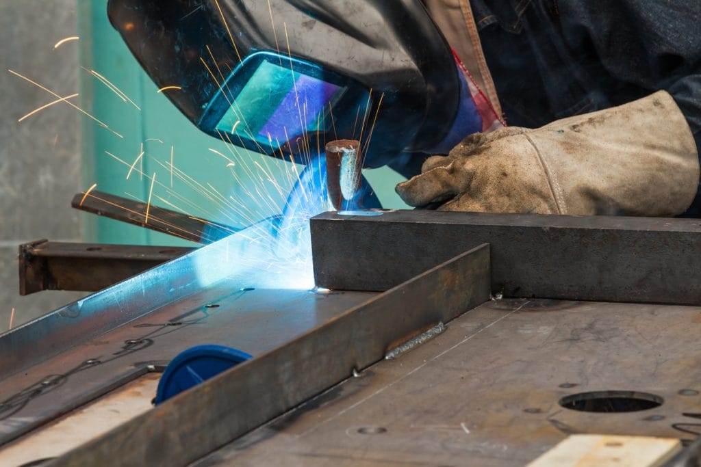 man welding with sparks coming off