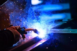 A person welding a piece of metal