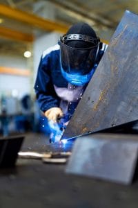 A person welding a piece of metal