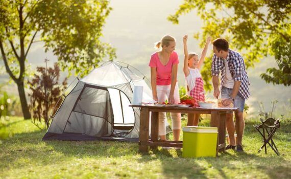 family camping preparing food with camping gas