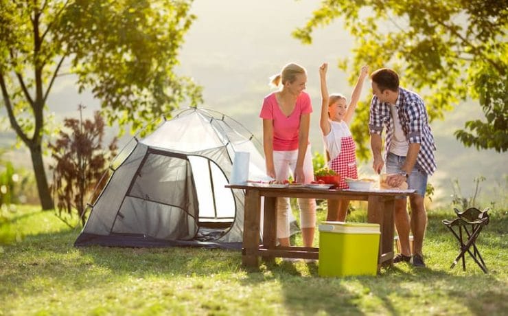 family camping preparing food with camping gas