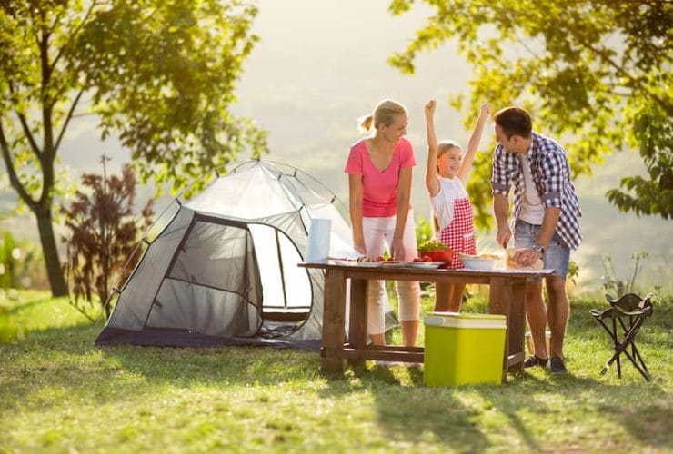 family camping preparing food with camping gas
