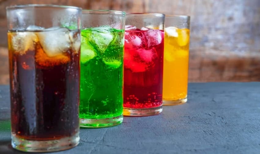 A row of glasses with different coloured drinks