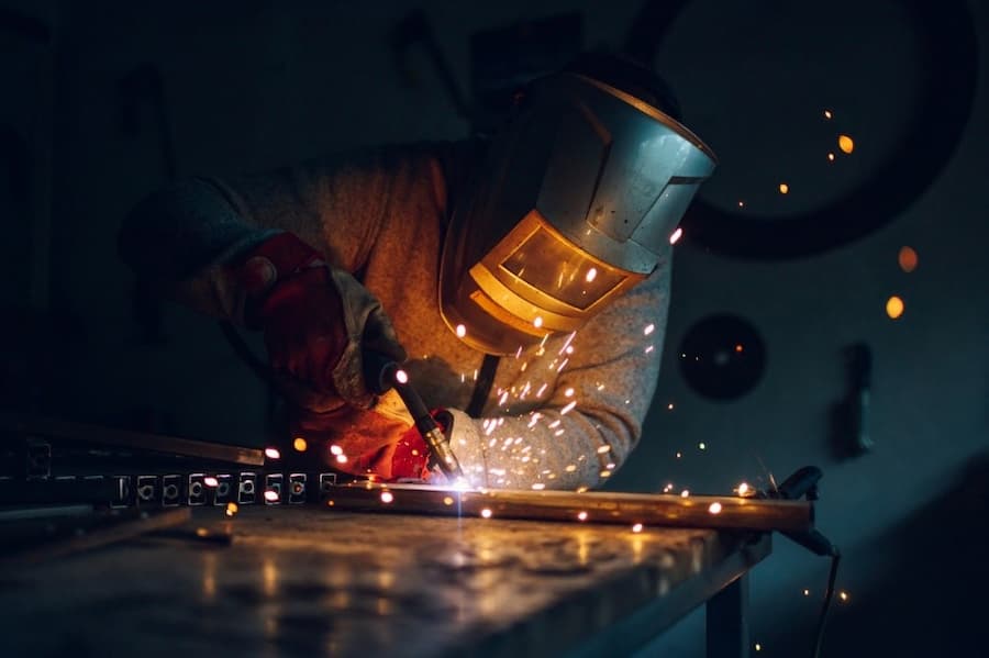 A person welding a piece of metal
