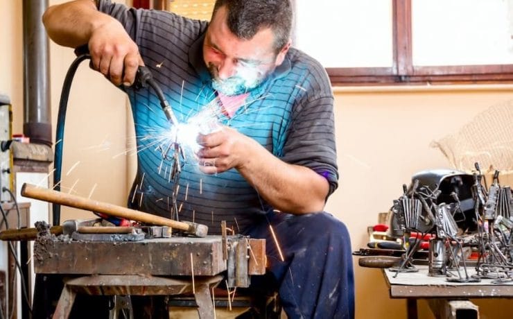 A person welding a piece of metal