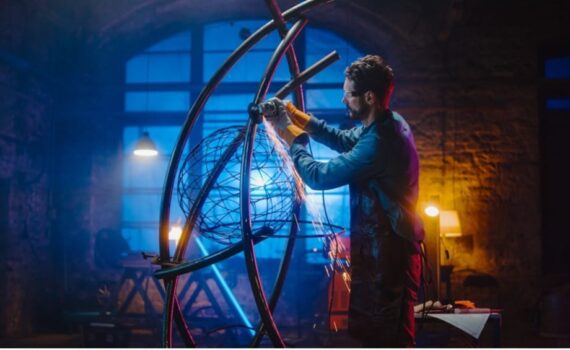 A person welding a sculpture