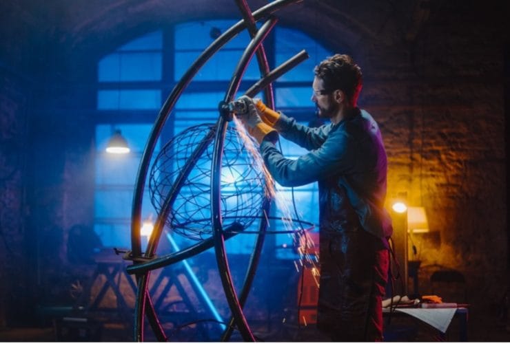 A person welding a sculpture