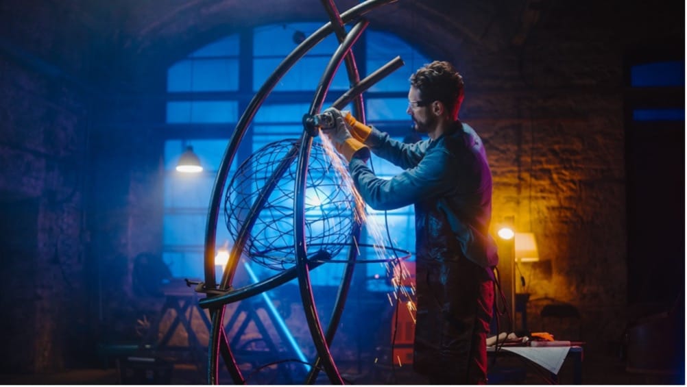 A person welding a sculpture