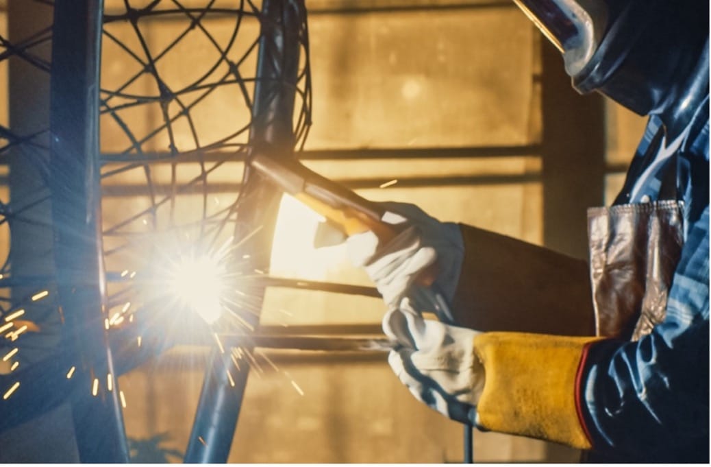A person welding a metal object