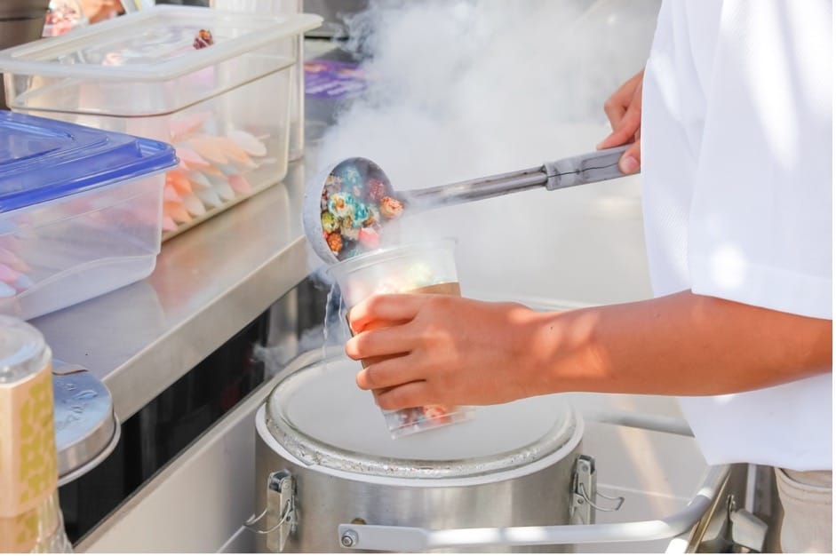 A person pouring food into a container