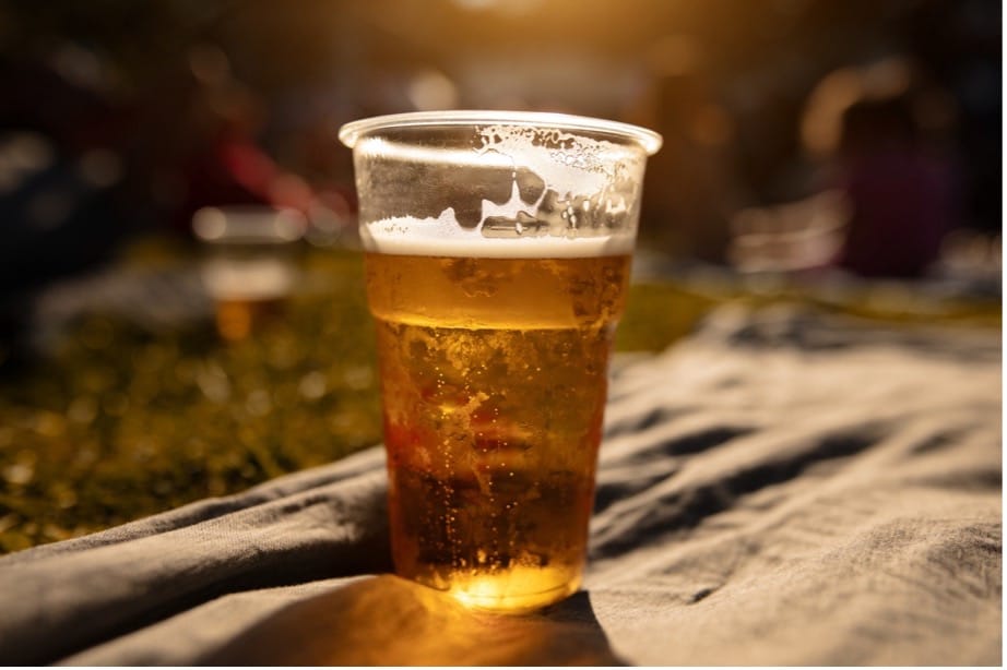 A cup of beer on a blanket