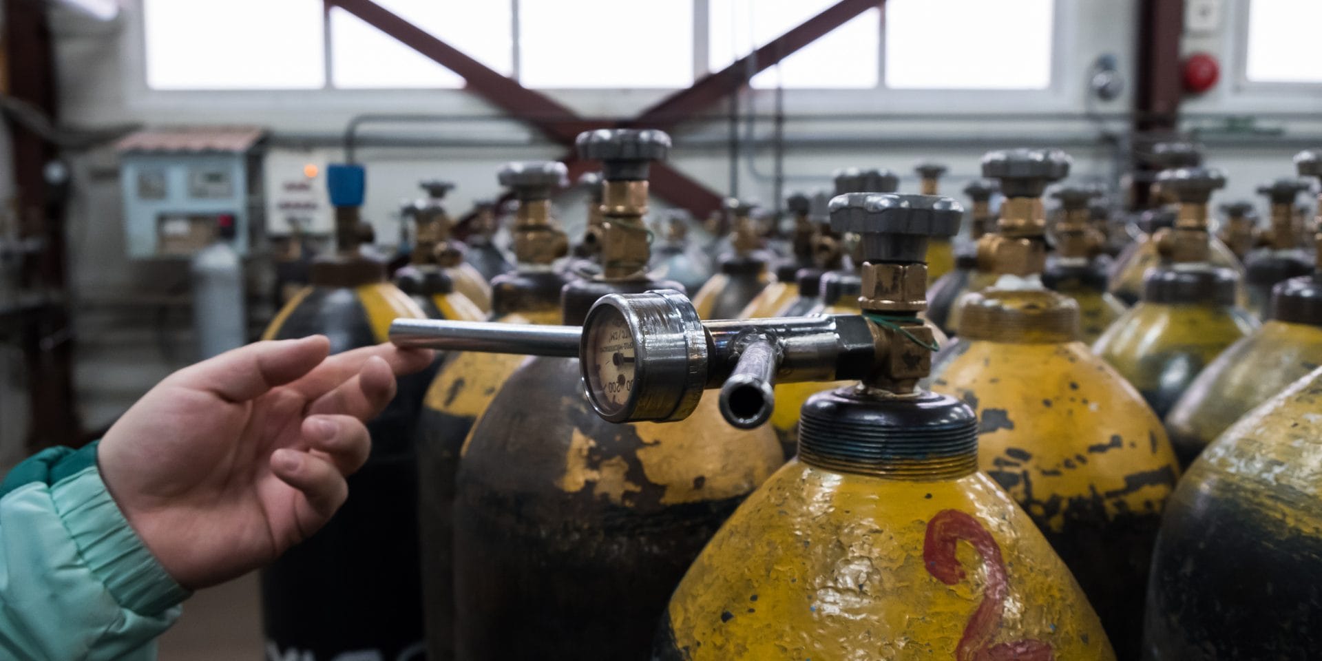 Pressure Tank and Regulator Gauges. Man checking manometer in liquid gas factory.