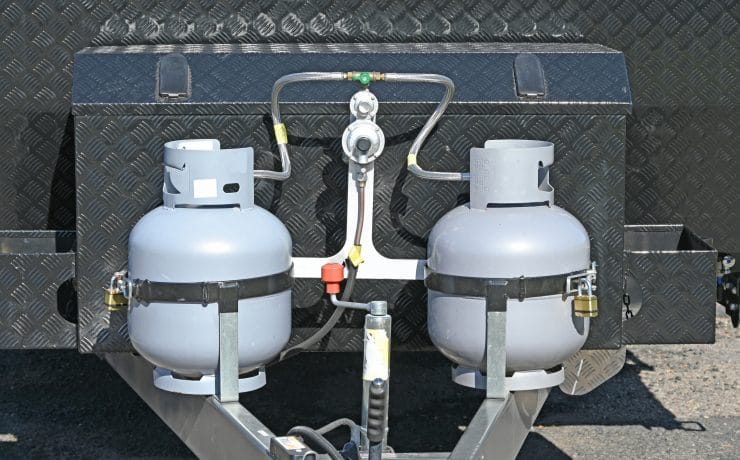 Two liquid petroleum gas bottles on the front of a caravan